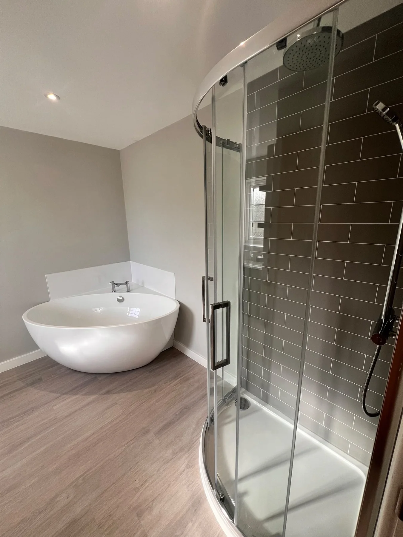 Freshly cleaned modern bathroom with bath and shower