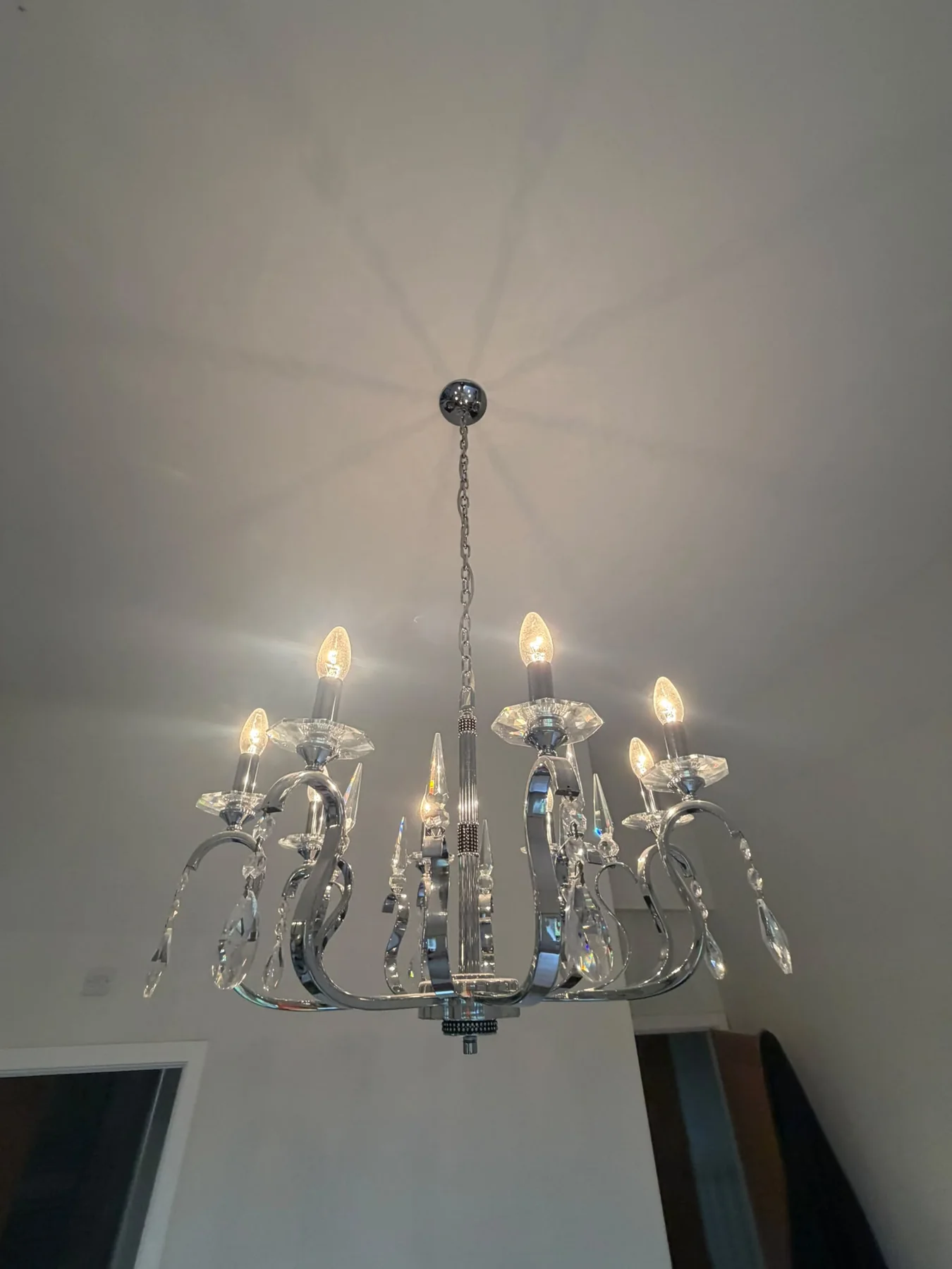 Clean chandelier and bright ceiling finish