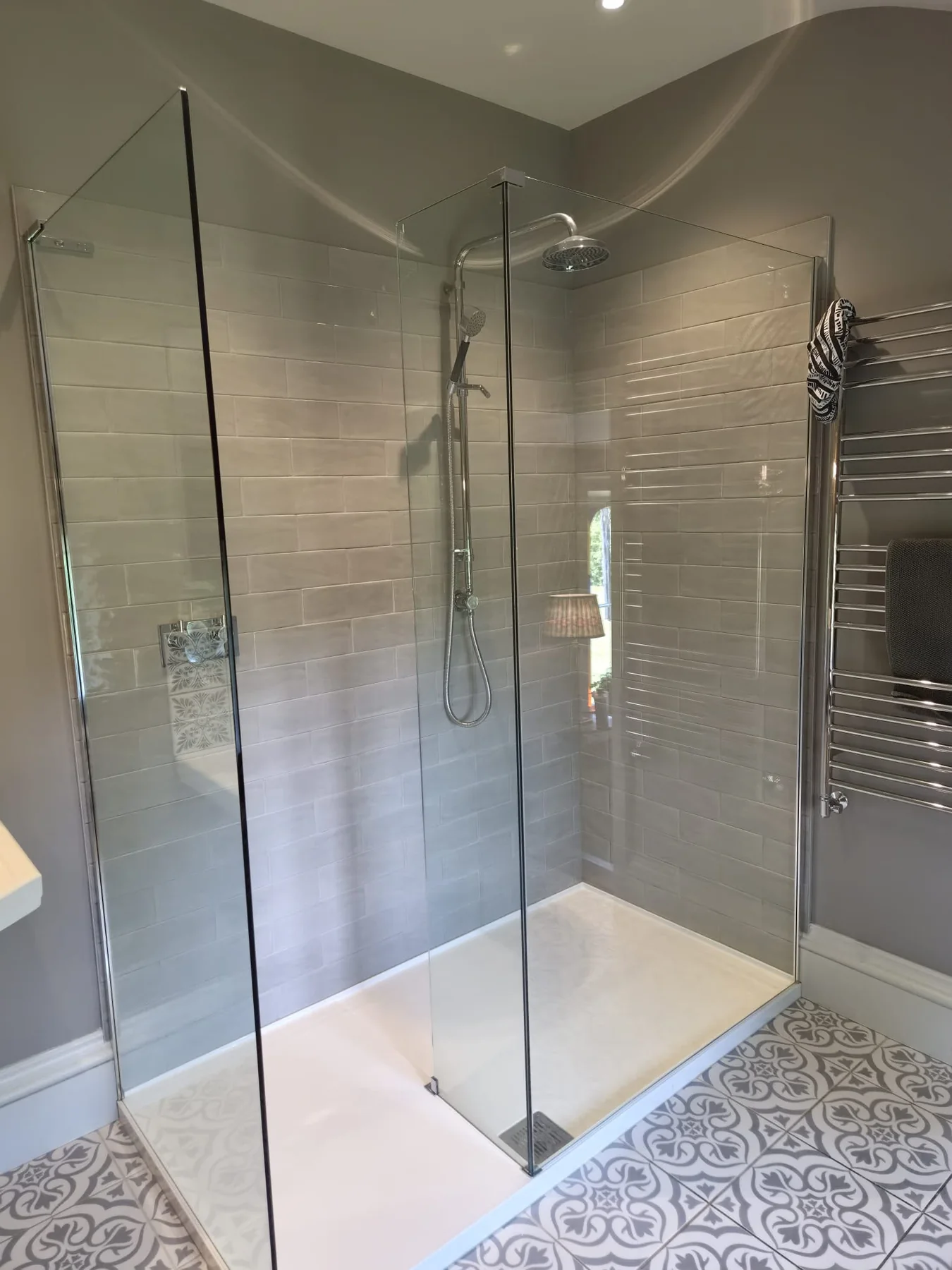 Walk-in shower with spotless glass and tiles