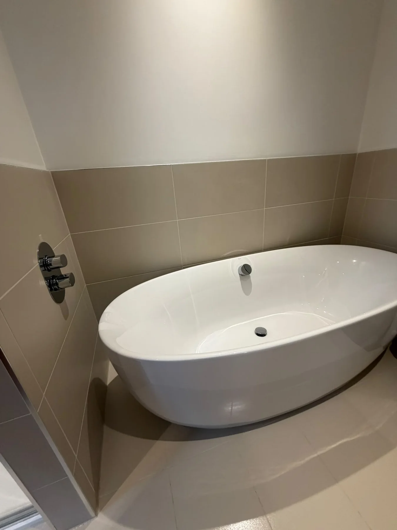 Freestanding bath with clean tiled surround